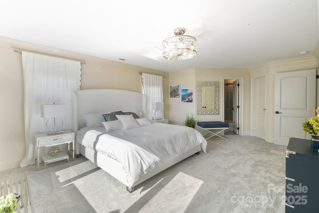 carpeted bedroom with crown molding, baseboards, an inviting chandelier, and visible vents