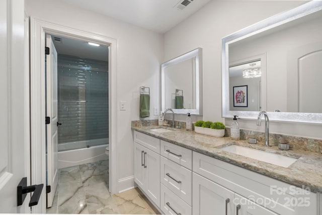 full bath with double vanity, visible vents, a sink, and marble finish floor