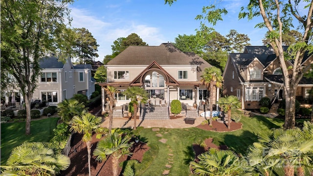back of property featuring a patio area, stucco siding, and a yard