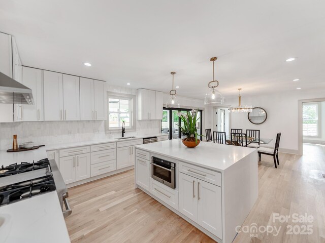 3501 Providence Rd, Charlotte, NC 28211 - kitchen featuring a sink, decorative backsplash, light wood finished floors, healthy amount of natural light, and recessed lighting