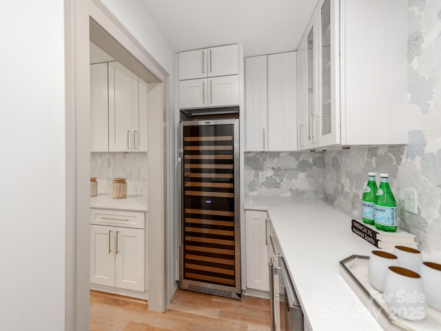 3501 Providence Rd, Charlotte, NC 28211 - kitchen featuring beverage cooler, light countertops, white cabinetry, light wood-style floors, and decorative backsplash
