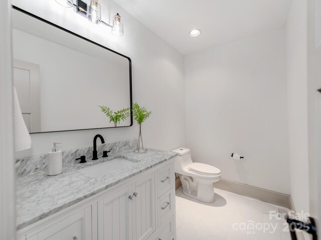 3501 Providence Rd, Charlotte, NC 28211 - half bathroom with toilet, vanity, recessed lighting, tile patterned flooring, and baseboards