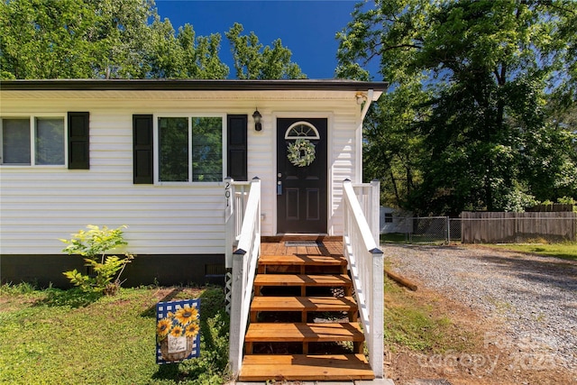 view of front facade featuring fence and crawl space