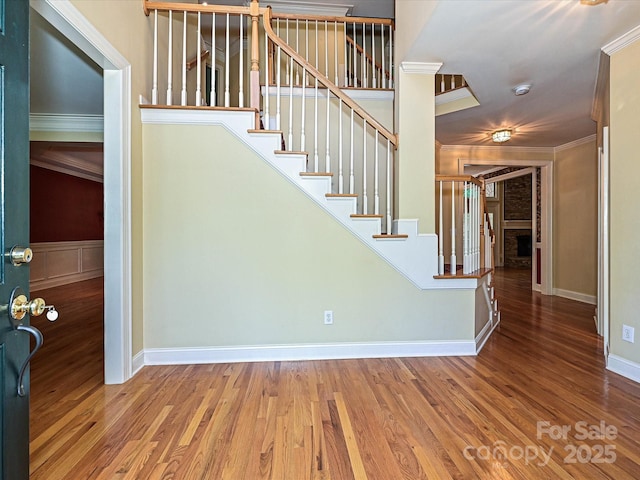 16511 Bridgehampton Club Dr, Charlotte, NC 28277 - stairway featuring ornamental molding, wood finished floors, baseboards, and a fireplace