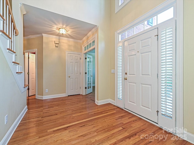 16511 Bridgehampton Club Dr, Charlotte, NC 28277 - foyer entrance with light wood-type flooring, ornamental molding, stairs, and baseboards