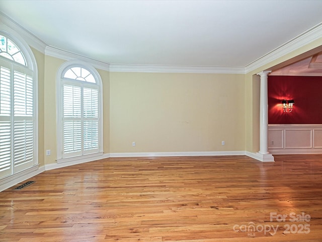 16511 Bridgehampton Club Dr, Charlotte, NC 28277 - empty room featuring decorative columns, ornamental molding, plenty of natural light, and wood finished floors
