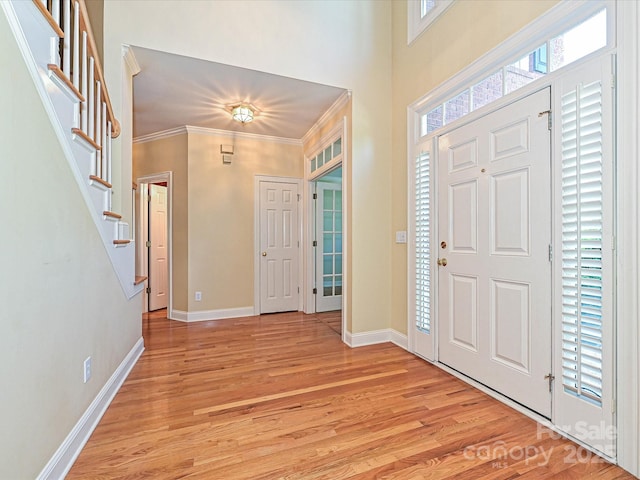 16511 Bridgehampton Club Dr, Charlotte, NC 28277 - entryway featuring light wood-style floors, crown molding, baseboards, and stairway