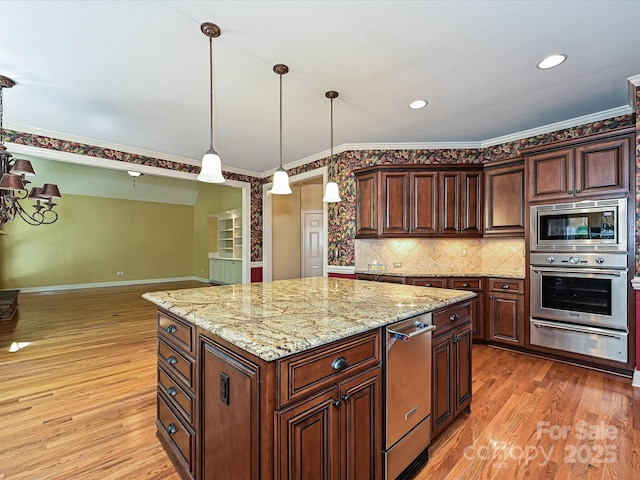 16511 Bridgehampton Club Dr, Charlotte, NC 28277 - kitchen featuring appliances with stainless steel finishes, a warming drawer, light wood-type flooring, crown molding, and light stone counters