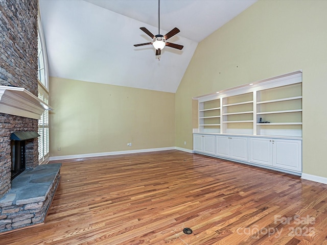 16511 Bridgehampton Club Dr, Charlotte, NC 28277 - unfurnished living room featuring high vaulted ceiling, wood finished floors, ceiling fan, a fireplace, and baseboards