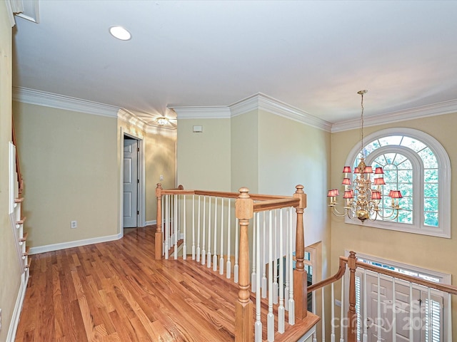 16511 Bridgehampton Club Dr, Charlotte, NC 28277 - hallway featuring an upstairs landing, wood finished floors, ornamental molding, baseboards, and a chandelier