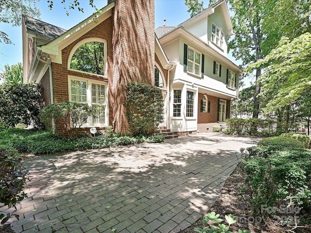 16511 Bridgehampton Club Dr, Charlotte, NC 28277 - back of house with brick siding, stucco siding, and entry steps
