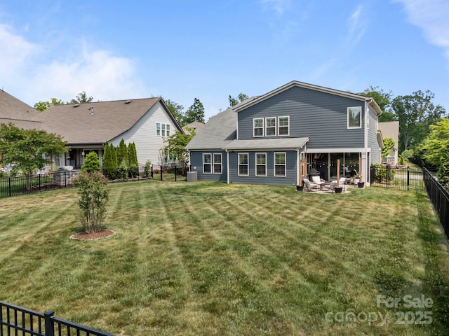 rear view of house featuring a fenced backyard and a yard