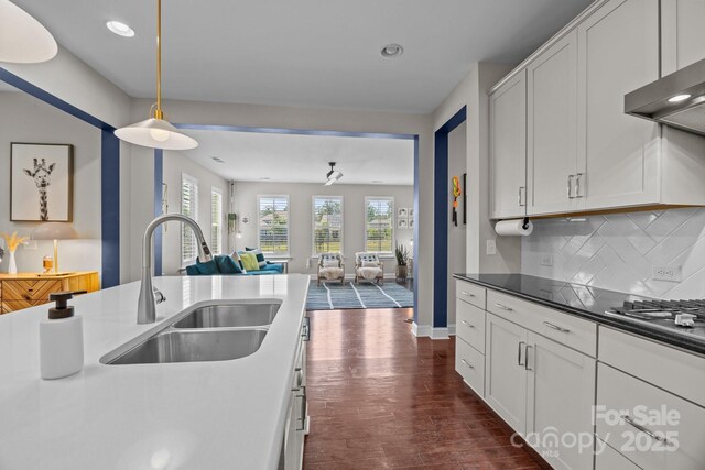 kitchen with a sink, dark wood-style flooring, recessed lighting, and open floor plan
