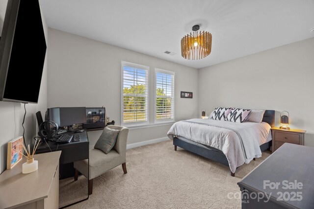 carpeted bedroom with baseboards and visible vents