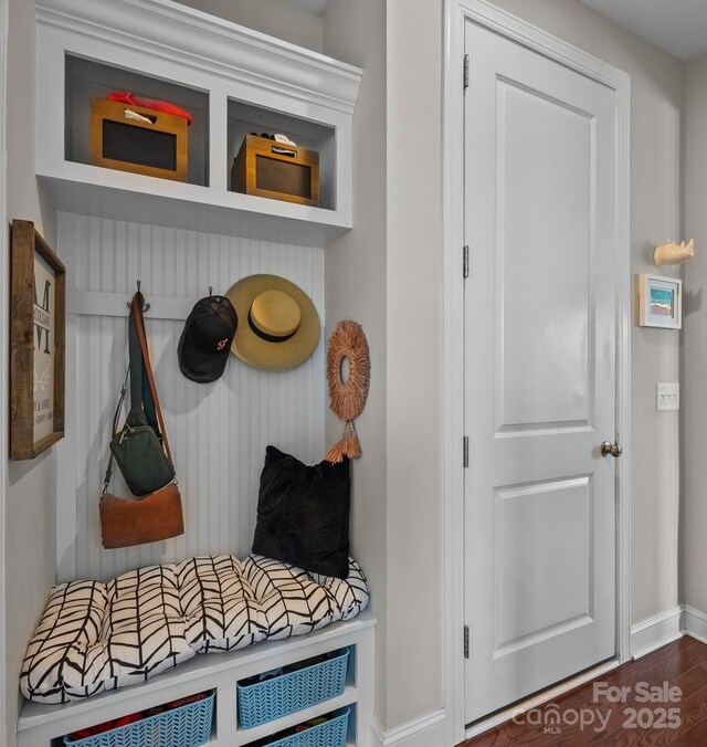 mudroom with baseboards and wood finished floors