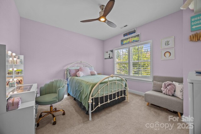 carpeted bedroom with visible vents, a ceiling fan, and baseboards