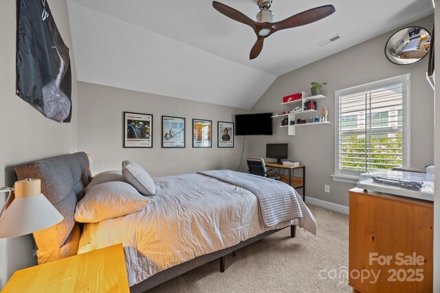 bedroom featuring visible vents, carpet floors, lofted ceiling, baseboards, and a ceiling fan