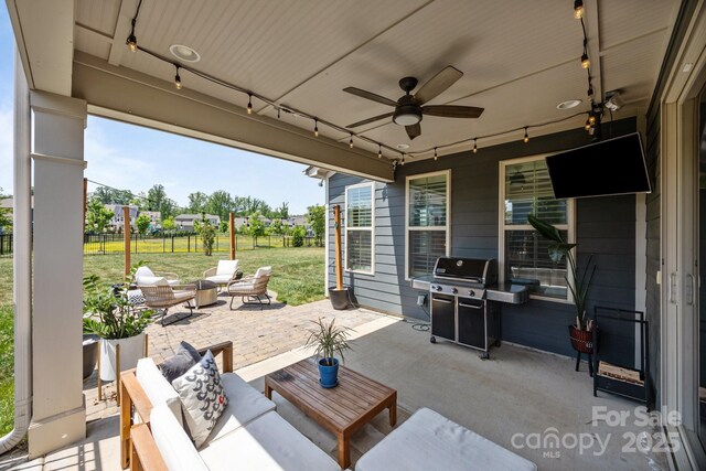 view of patio / terrace featuring fence, a ceiling fan, a grill, and outdoor lounge area