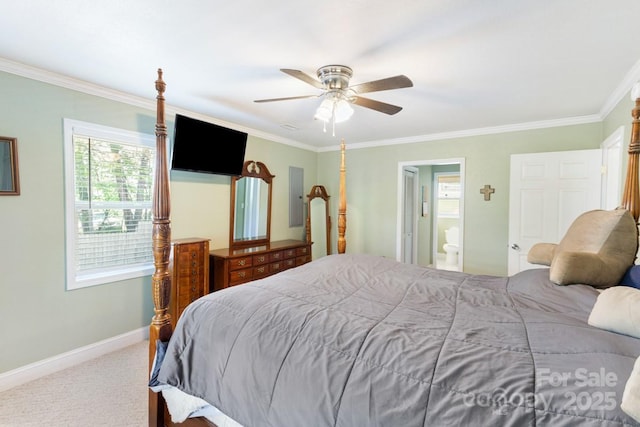 carpeted bedroom with baseboards, ceiling fan, ornamental molding, and ensuite bathroom
