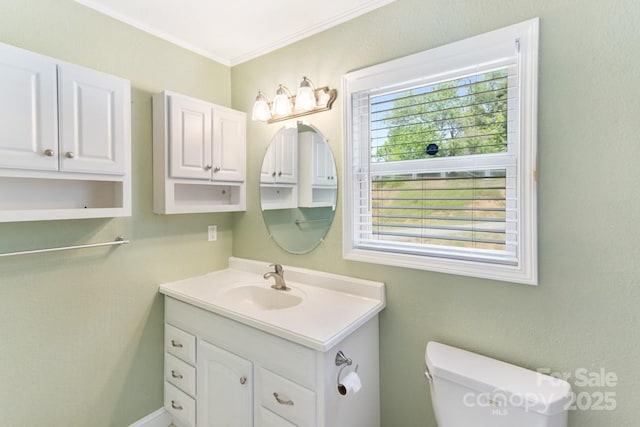 bathroom featuring crown molding, toilet, and vanity
