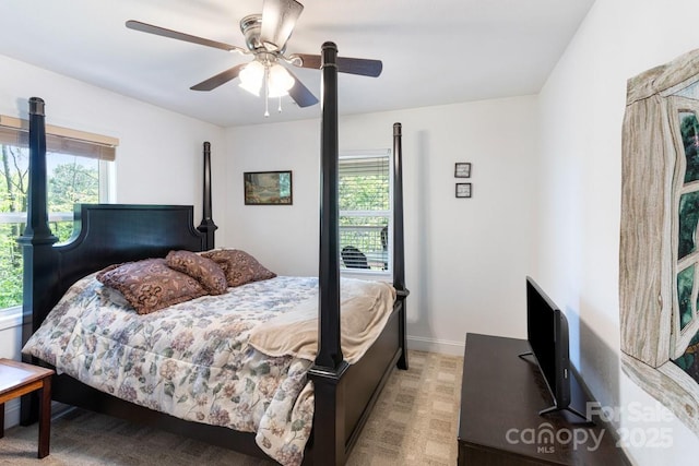 bedroom with baseboards, multiple windows, and ceiling fan