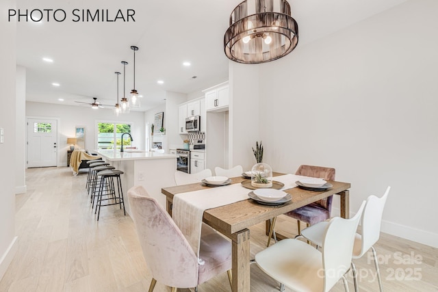 dining area with ceiling fan, light wood-style flooring, baseboards, and recessed lighting
