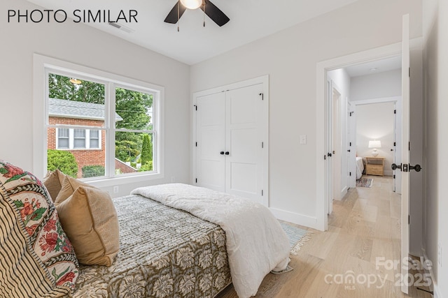 bedroom with light wood-style flooring, a ceiling fan, a closet, visible vents, and baseboards