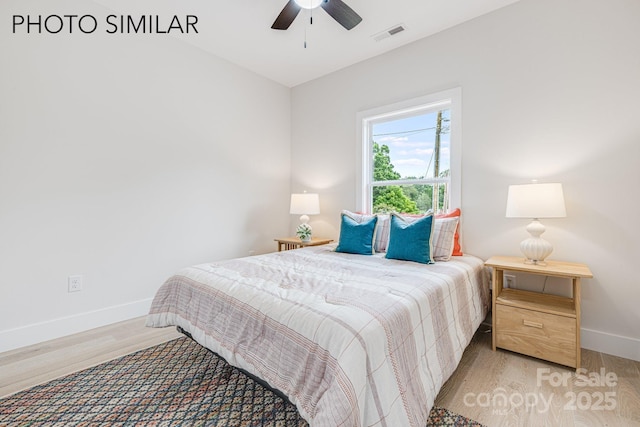 bedroom featuring baseboards, ceiling fan, light wood finished floors, and visible vents