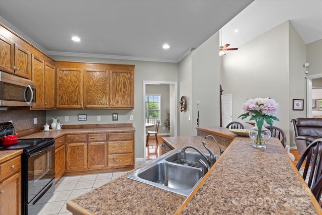 kitchen with black / electric stove, a ceiling fan, a sink, light tile patterned floors, and stainless steel microwave