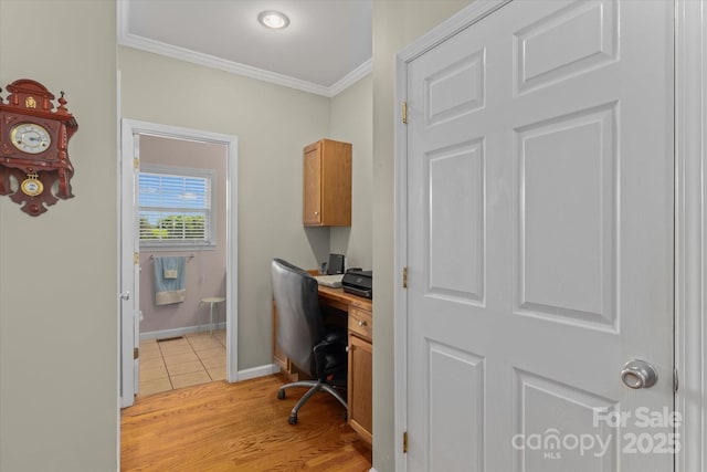home office featuring crown molding, baseboards, and light wood-type flooring