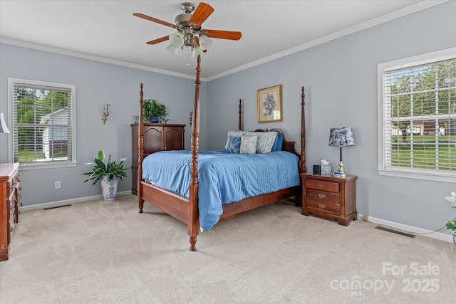 bedroom featuring crown molding, baseboards, multiple windows, and light colored carpet