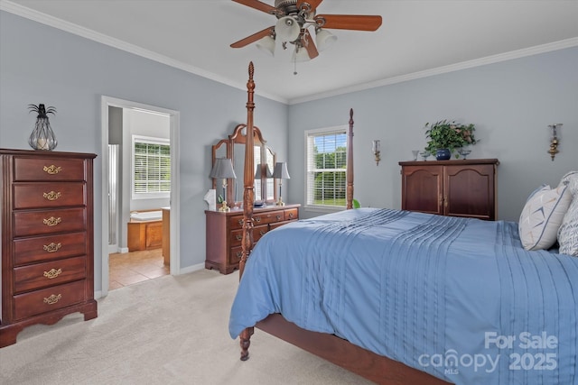 bedroom featuring ceiling fan, light carpet, baseboards, ensuite bathroom, and ornamental molding