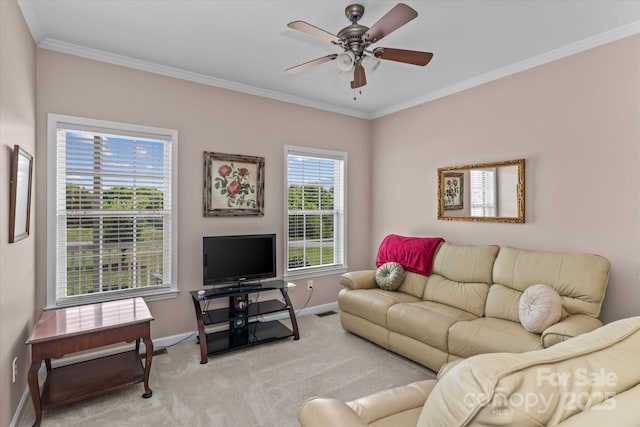 living room featuring baseboards, a ceiling fan, crown molding, and light colored carpet