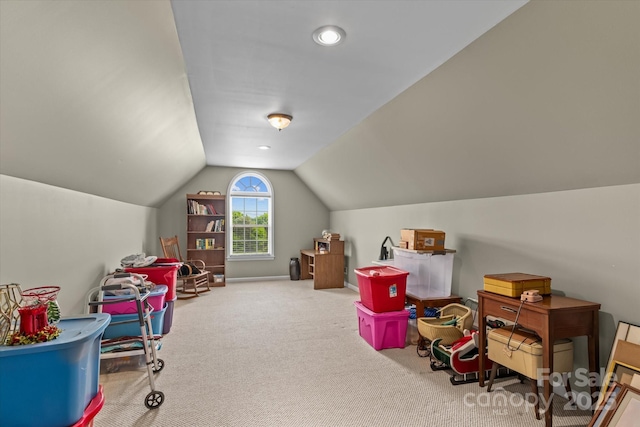 rec room featuring carpet floors and vaulted ceiling