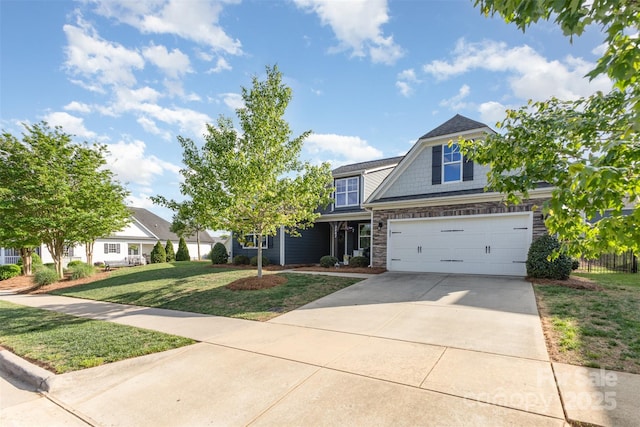 view of front of property with driveway, a front yard, fence, an attached garage, and stone siding