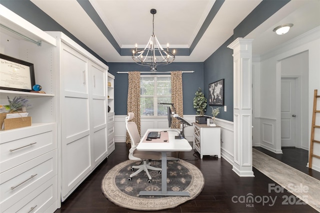office with crown molding, dark wood finished floors, a wainscoted wall, decorative columns, and a tray ceiling