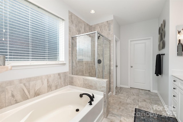 full bath with vanity, baseboards, recessed lighting, a bath, and a shower stall