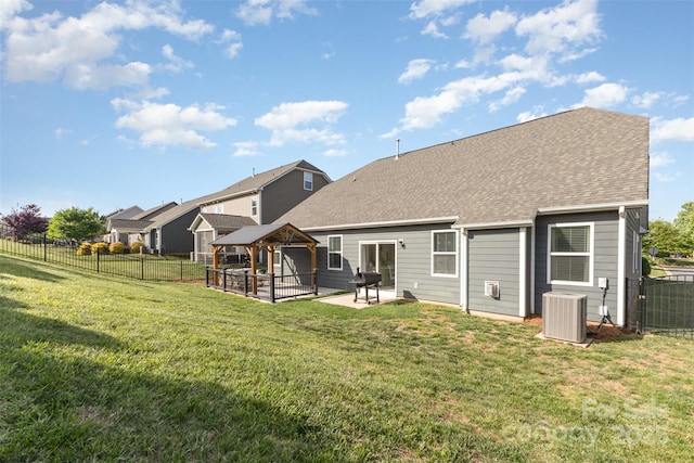 back of house featuring cooling unit, a patio, a fenced backyard, a gazebo, and a yard