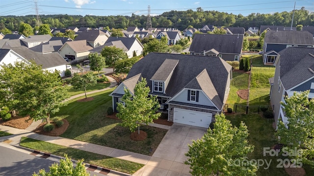 birds eye view of property with a residential view