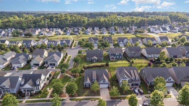 birds eye view of property featuring a view of trees and a residential view