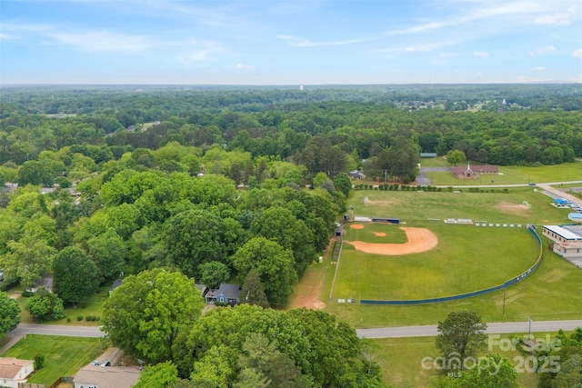 birds eye view of property with a forest view