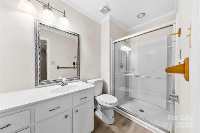 full bathroom featuring crown molding, visible vents, wood finished floors, toilet, and a stall shower