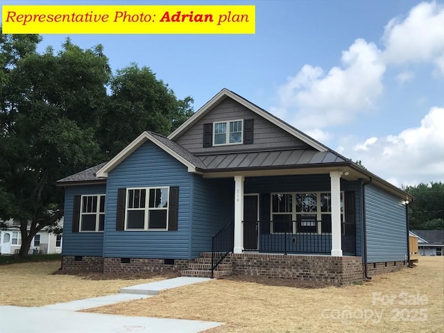 view of front of home with metal roof, covered porch, crawl space, and a standing seam roof