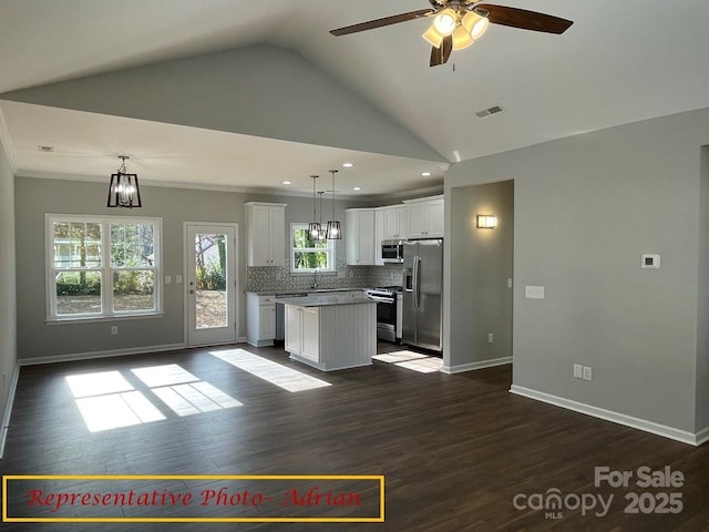 kitchen featuring visible vents, a kitchen island, ceiling fan, white cabinetry, and appliances with stainless steel finishes
