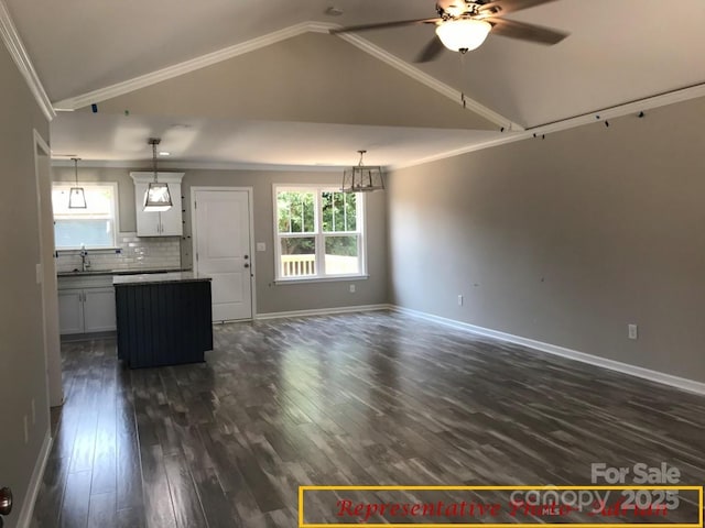 unfurnished living room with a sink, a ceiling fan, baseboards, vaulted ceiling, and dark wood-style floors
