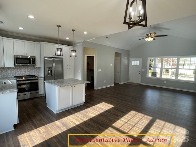 kitchen with a kitchen island, stainless steel appliances, ceiling fan, and white cabinets