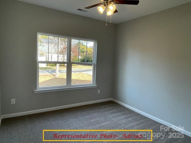 carpeted spare room featuring baseboards, ceiling fan, and visible vents