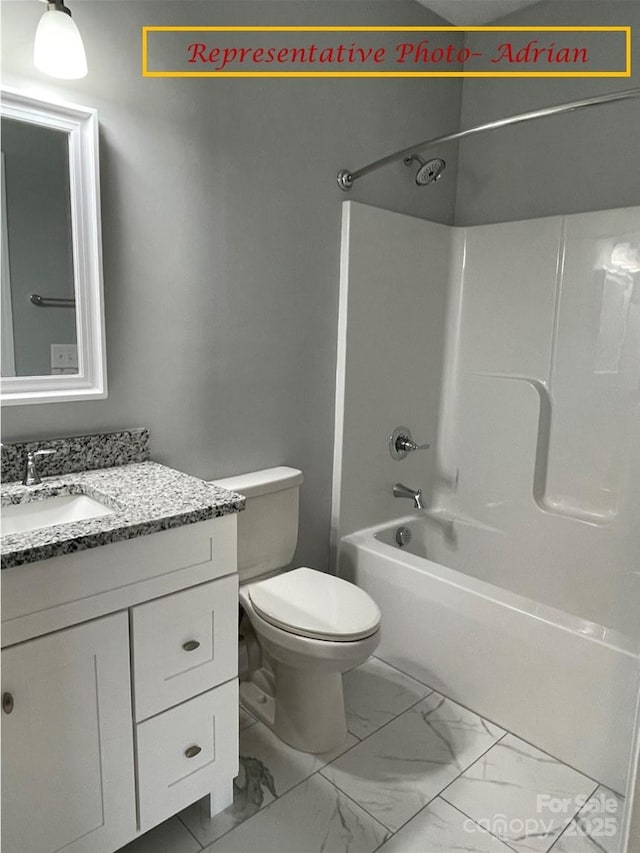 full bathroom with vanity, marble finish floor, toilet, and shower / washtub combination