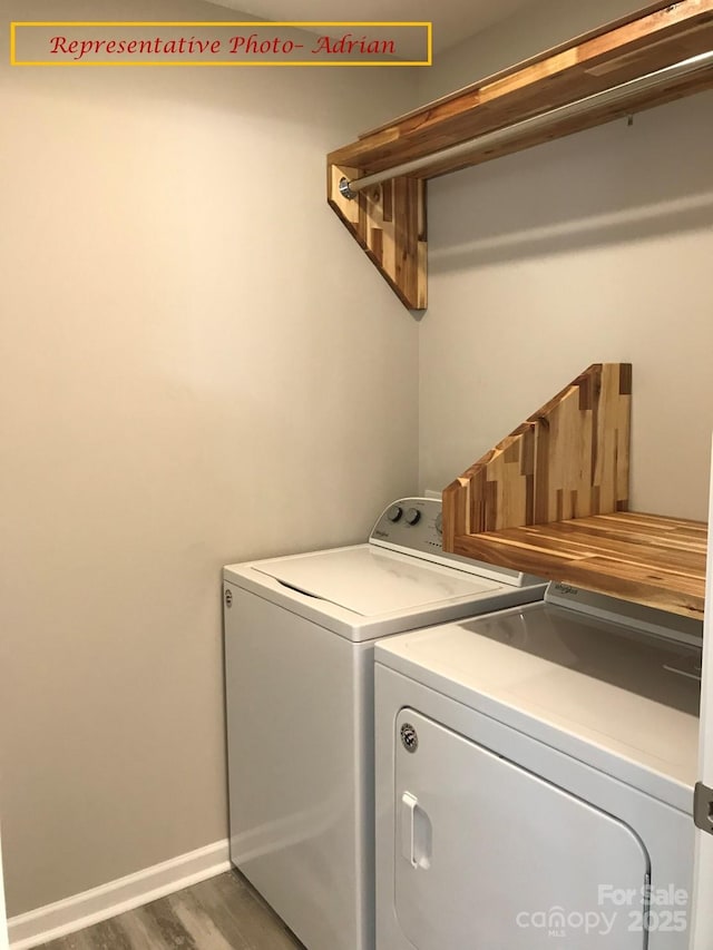 laundry room featuring laundry area, dark wood-style flooring, baseboards, and washing machine and clothes dryer