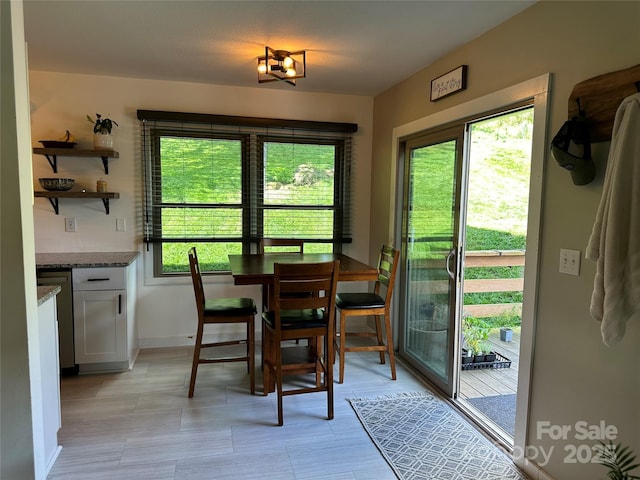 dining room with baseboards and plenty of natural light